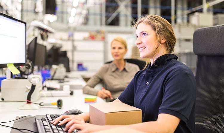 Women-in-a-warehouse-working-on-a-computer-1